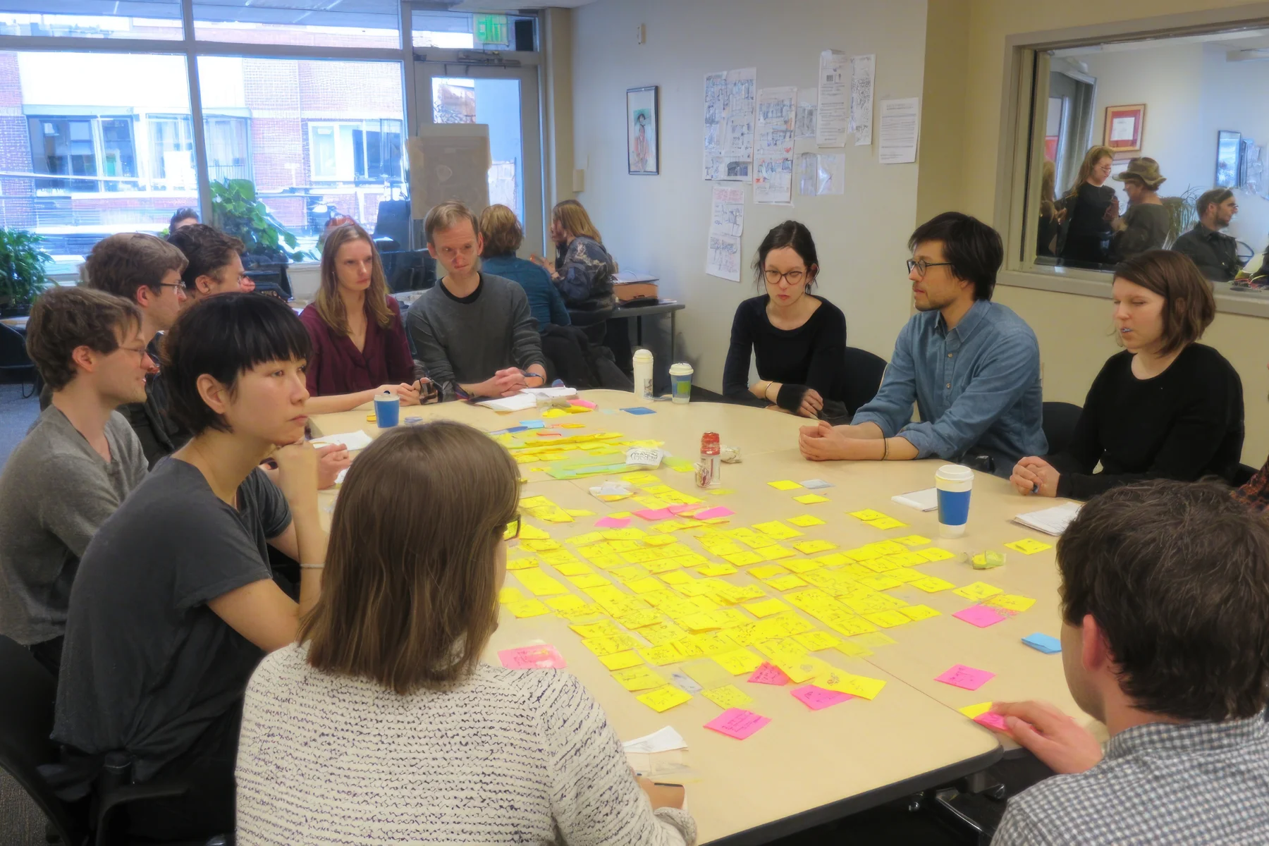group of people gathered in a table doing social activity