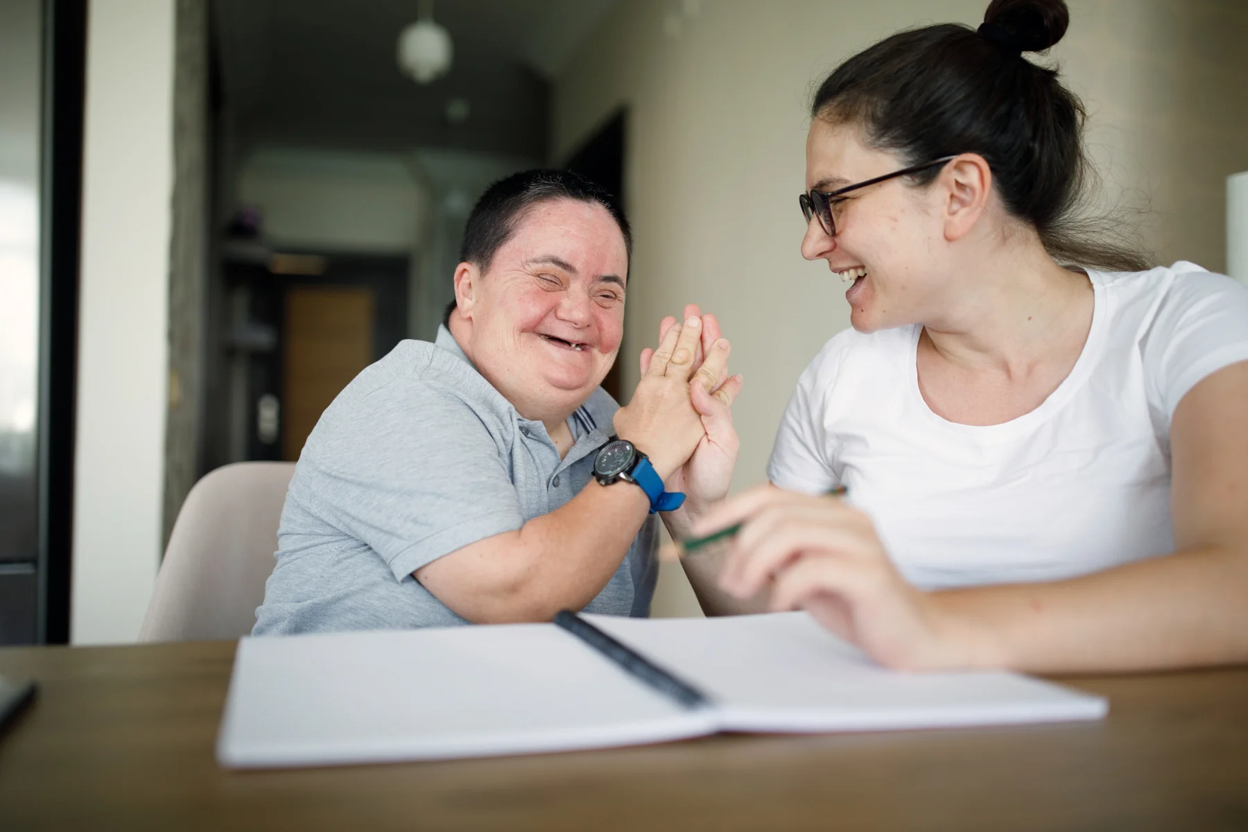 two people laughing while studying